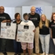 Entergy volunteers at a fan giveaway with a customer.