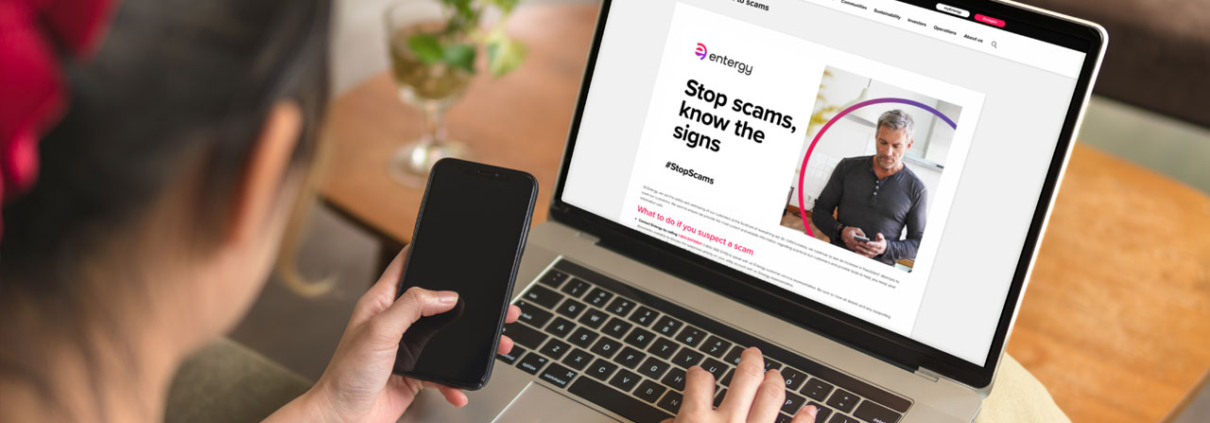 Customer pondering scam-information website on laptop