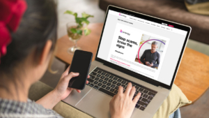 Customer pondering scam-information website on laptop