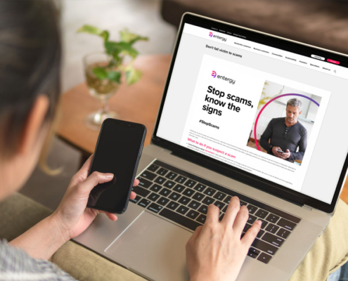 Customer pondering scam-information website on laptop