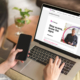 Customer pondering scam-information website on laptop