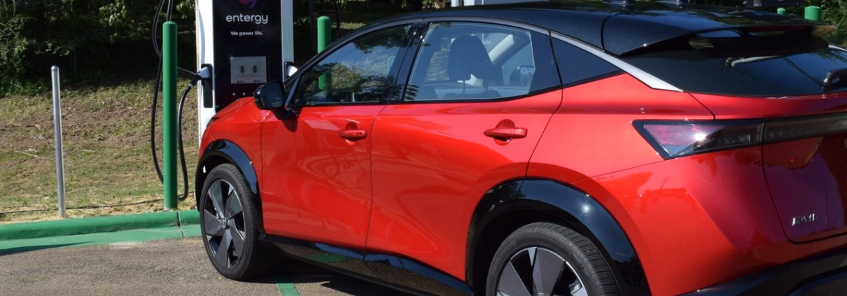 Red car at electric charging station