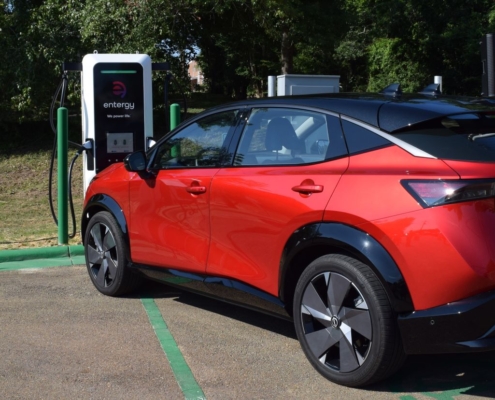 Red car at electric charging station