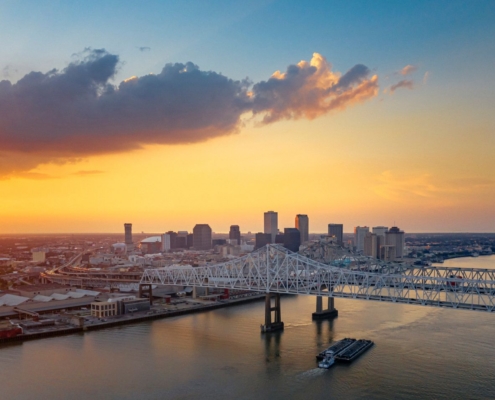 A ship is under the New Orleans bridge in the evening from above